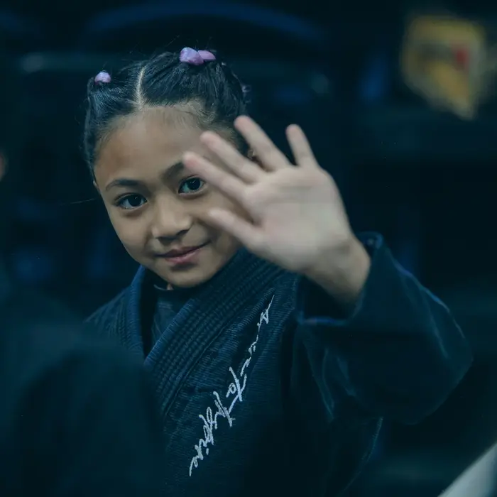 Young student in a gi at By Any Means Jiu-Jitsu kids class