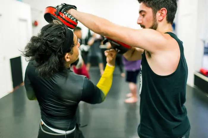 Members sparring during a kickboxing class