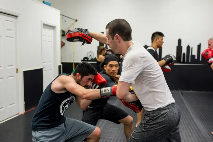 Coach leading a kickboxing strategy class