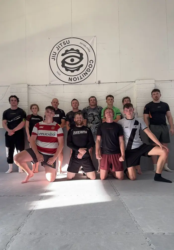 Cognition Jiu Jitsu members gathered under the academy banner after a no-gi class in Ulverston