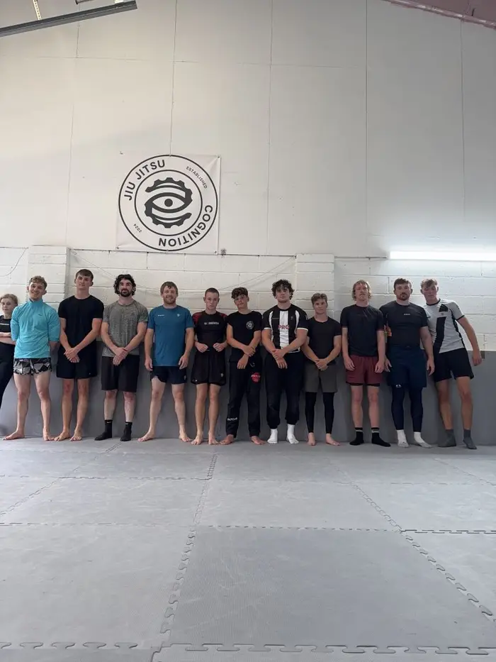 A full Cognition Jiu Jitsu class standing together on the mats in Ulverston