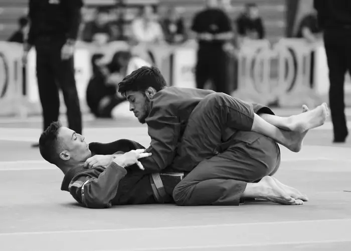 BJJ competitor passing guard at a tournament