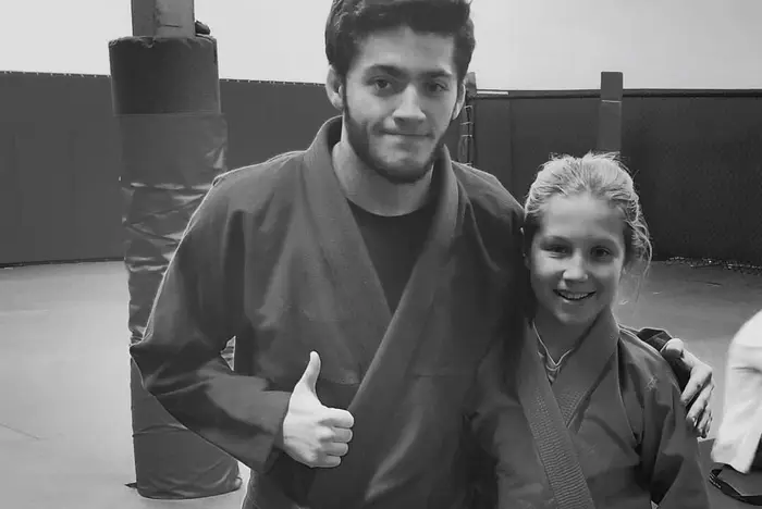 Connors instructor with a young jiu jitsu student