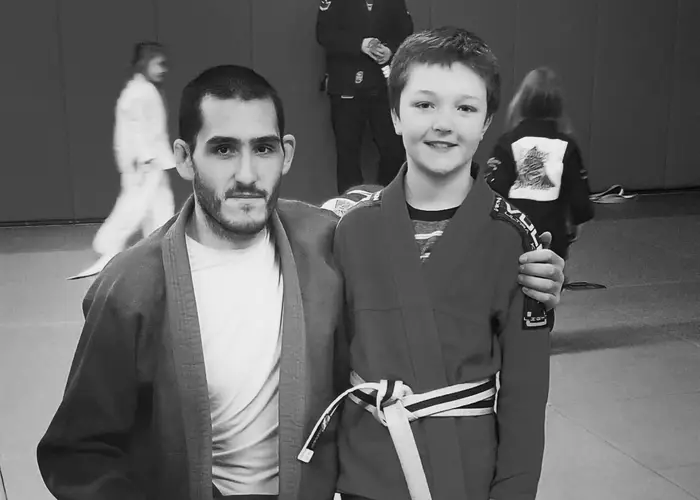 Coach with a youth student after a belt promotion
