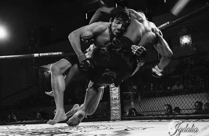 Connors athlete competing in an MMA cage match