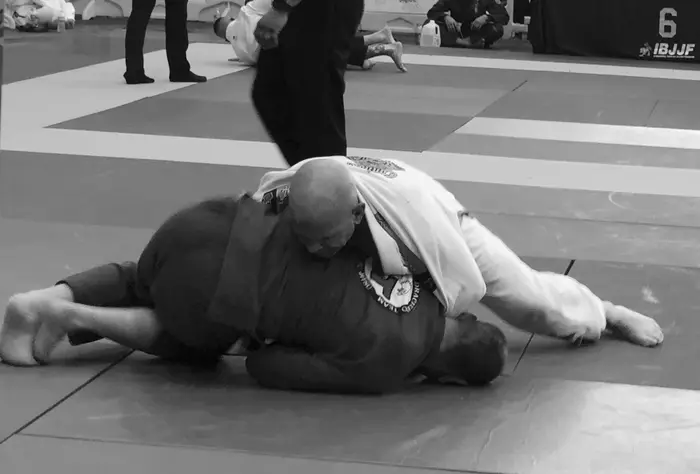 Student controlling an opponent at an IBJJF tournament