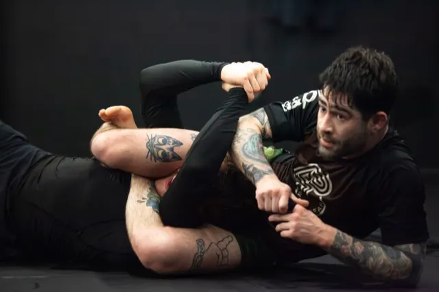 Athlete working a leg lock position