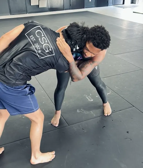 Standing grappling exchange in a CSG rashguard