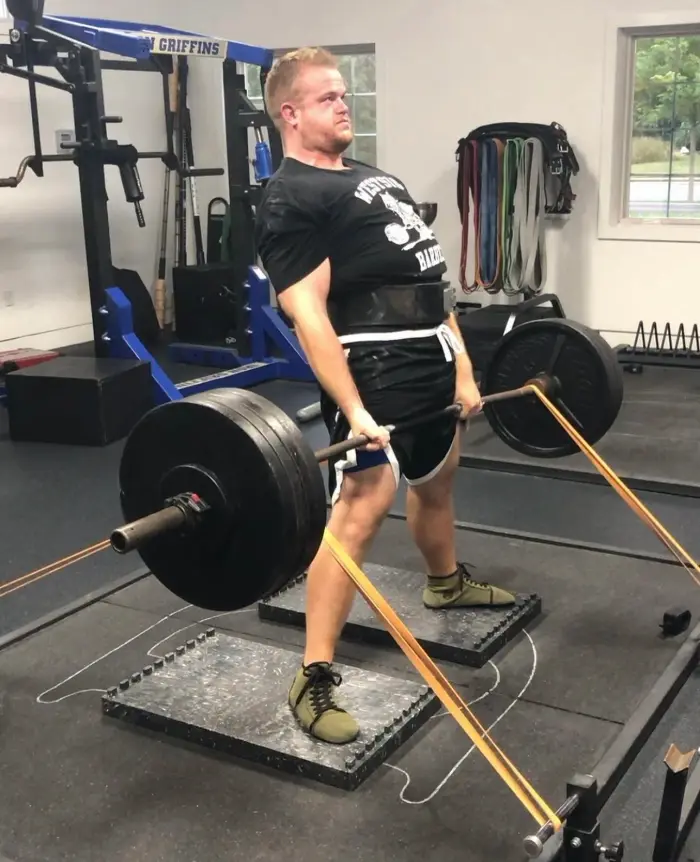Athlete setting up for a heavy barbell deadlift in the gym