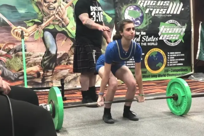Athlete pulling a deadlift on the competition platform