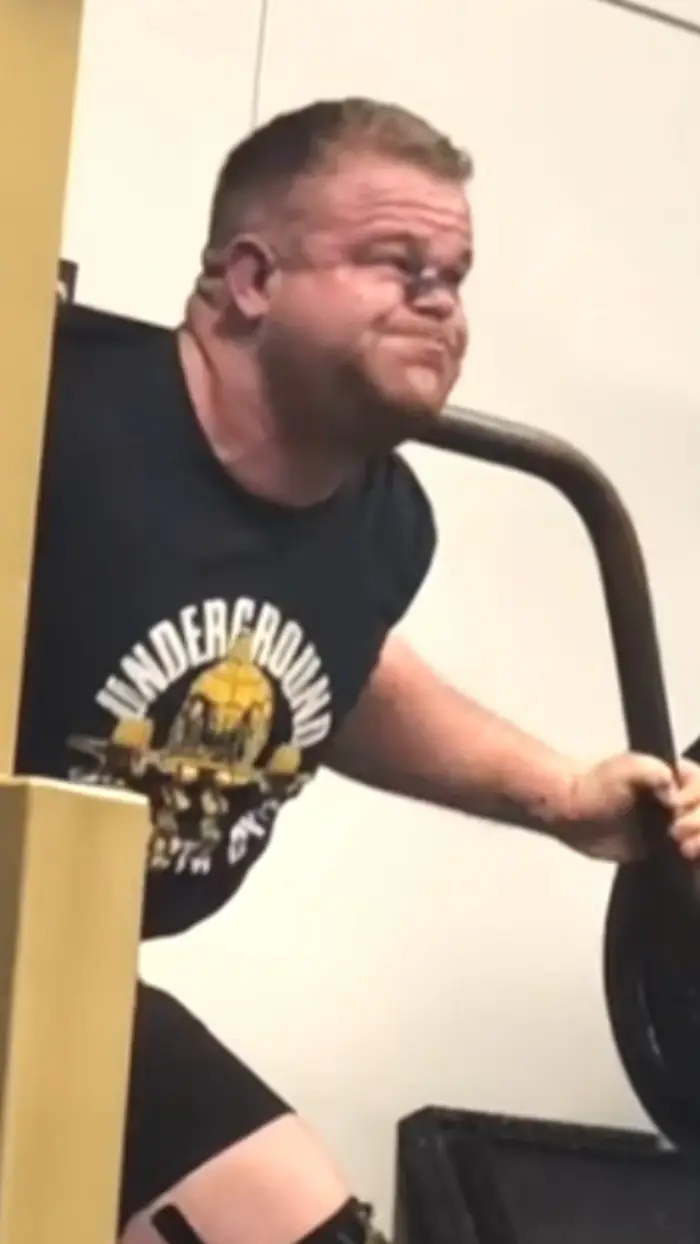 Coach Titus through a max-effort lift in the training hall