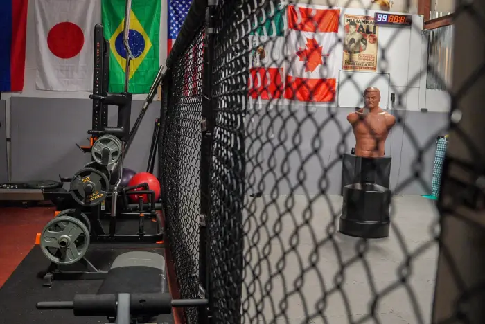 Grappler working from his back in the cage