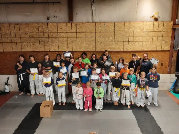 Youth martial arts class group photo with certificates