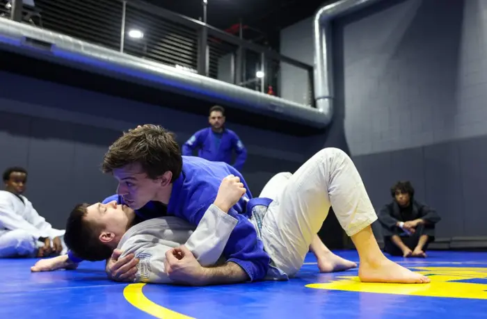 Coach Drake teaching a BJJ pin on the mats