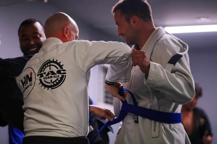 Adults rolling during a no-gi jiu jitsu class