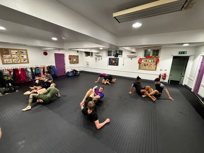 Students training Brazilian Jiu Jitsu in class at Hook Grappling