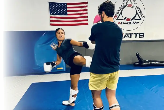 Muay Thai pad work — a student throwing a knee on focus mitts at Paragon Simi Valley
