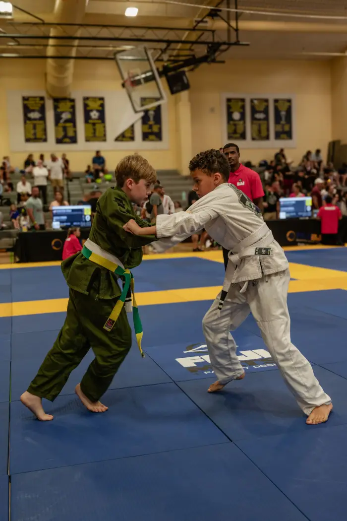 Young Revive students gripping up during a jiu jitsu match