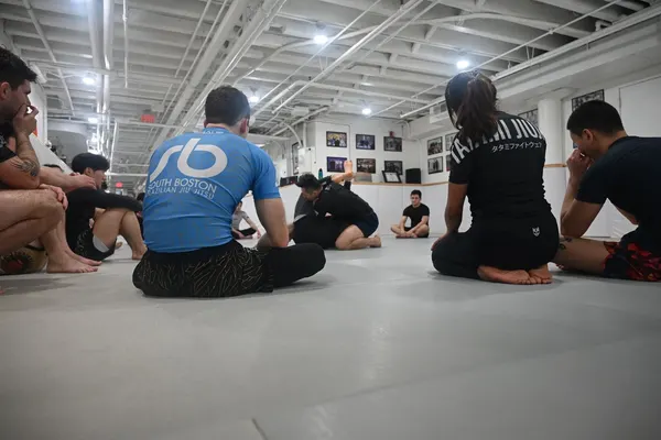 Members seated on the mats during a class at South Boston BJJ