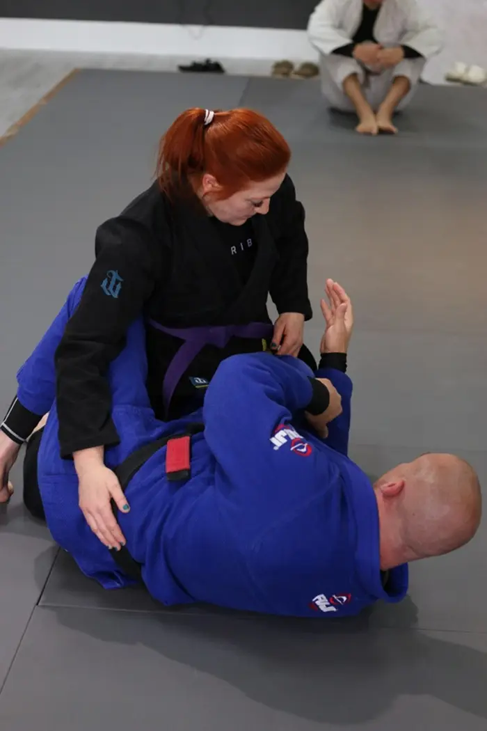 Student training Brazilian Jiu Jitsu on the mats