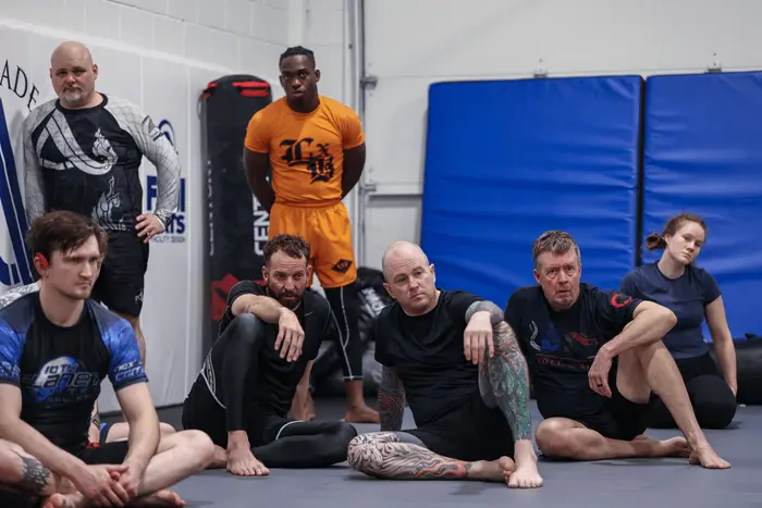 Coaches and students gathered on the mats at The Academy Eden Prairie