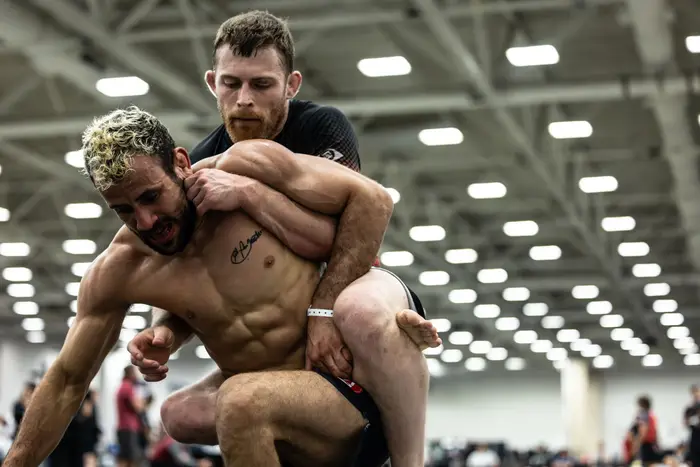 Coach Jordan Holy taking the back in a no-gi competition match