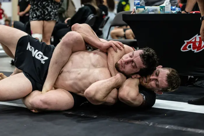 Two Holy Grail athletes grappling during open mat training
