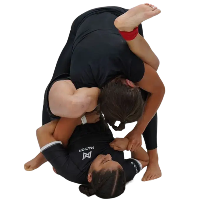 Students drilling submission grappling positions on the mats