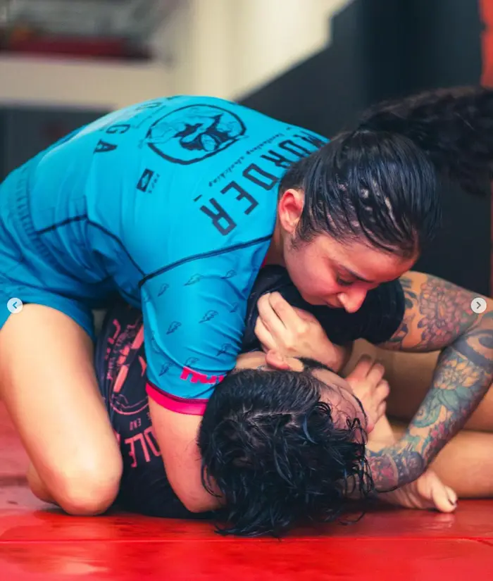 Two practitioners rolling during open training at The Jiu Jitsu Lounge