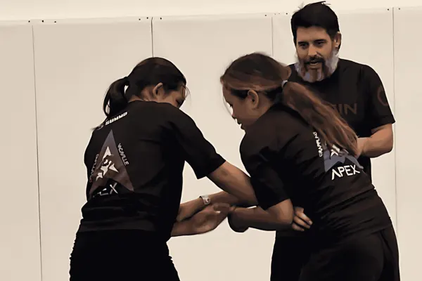 Youth students drilling takedowns with Coach Nick